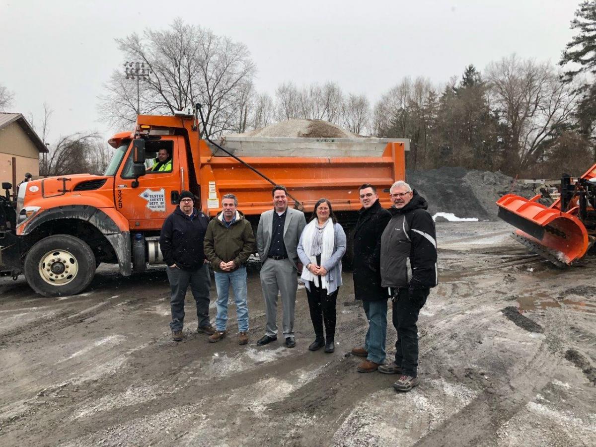 1)	Acting County Executive Adele B. Reiter and Deputy County Executive Marc Rider with staff from the Ulster County Department of Public Works prior to commencement of winter operations on Tuesday morning. Pictured (L to R), Wayne Crispino, CEO I (in vehicle); Brendan Masterson, Highway and Bridges Field Operations Manager; Bob Buser, Deputy Commissioner for Buildings; Marc Rider, Deputy County Executive; Adele B. Reiter, Acting County Executive; Don Quesnell, Deputy Comissioner for Finance; Ron Suits, Deputy Commissioner for Capital Contracts. Not pictured, but assisting with Tuesday’s storm preparations: Jack McGarril, Section Supervisor; Lauren Pedersen, CEO II; Steve Benicase, CEO I. 