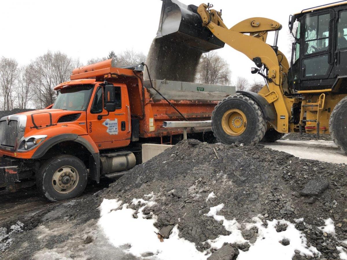 2)	A DPW crew loads sand at the Kingston DPW Headquarters as snow begins to fall on Tuesday morning.